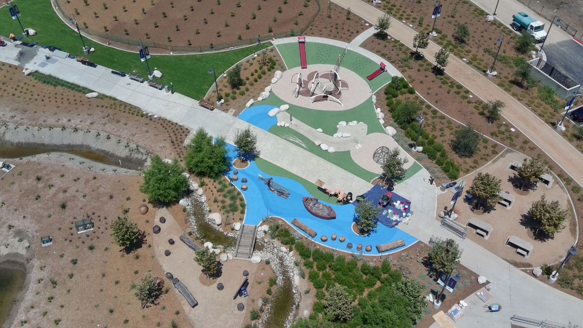 Barely more than seedlings and saplings today, hundreds of shrubs and trees will soon blanket the park with a cooling canopy of shade, purify the air, and provide a bounty of free, fresh fruit.