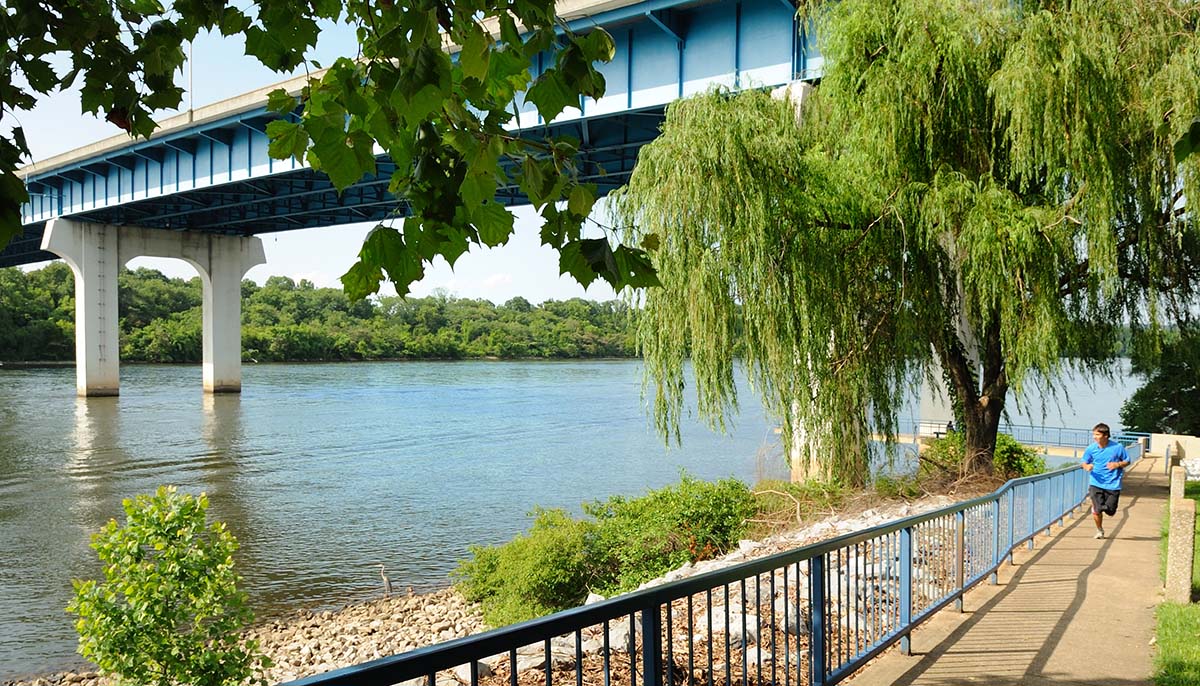 A young man jogs along the Tennessee Riverpark