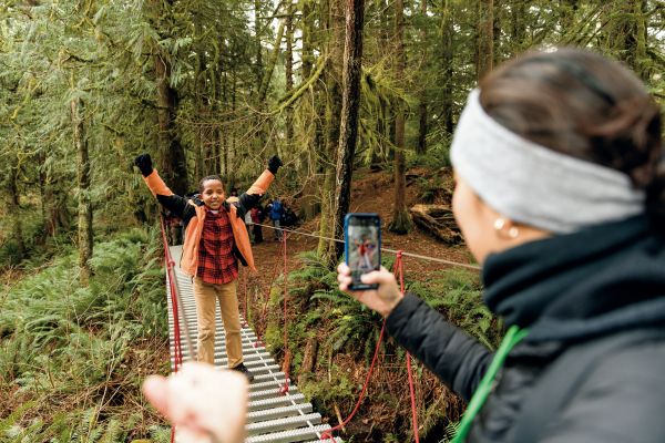 Yusuf, a fifth grader attending Camp Waskowitz Outdoor Education Center, felt triumphant upon crossing a suspension bridge.