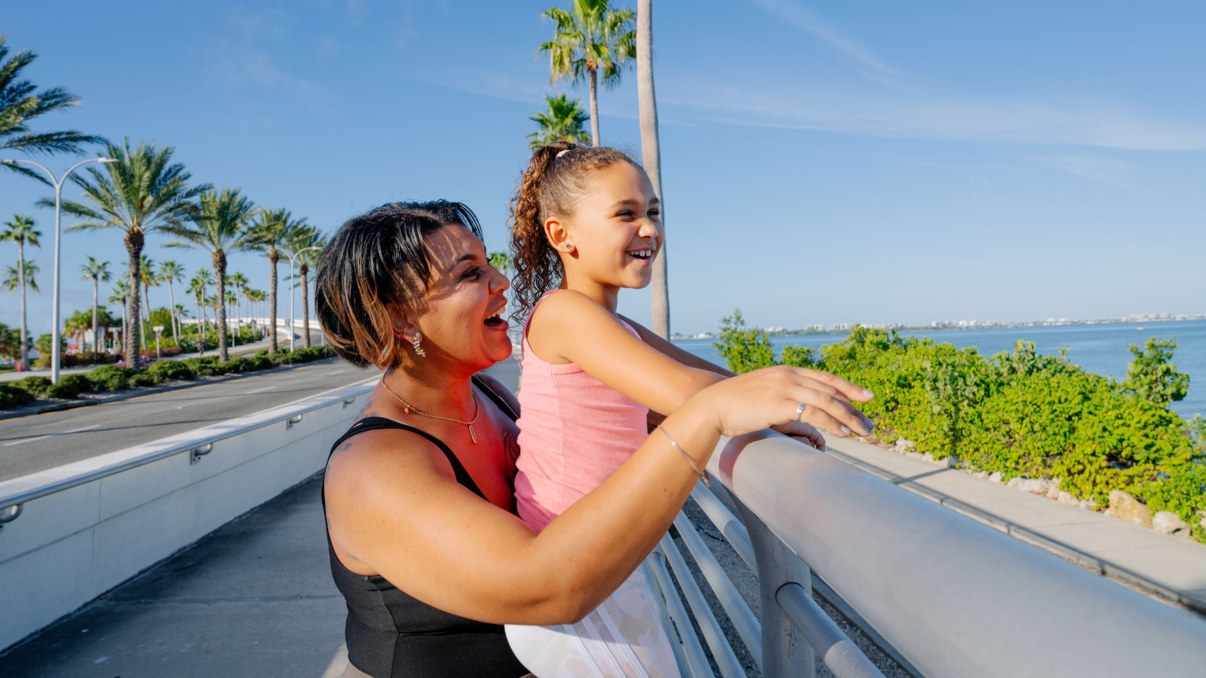 Woman and child enjoying the scenic overlook of the Florida Gulf Coast Trail.