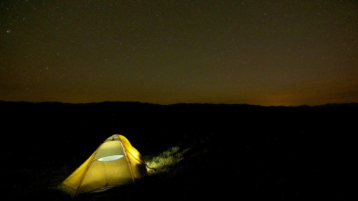 A tent under a star-filled sky in the Upper Hoback region in Wyoming.
