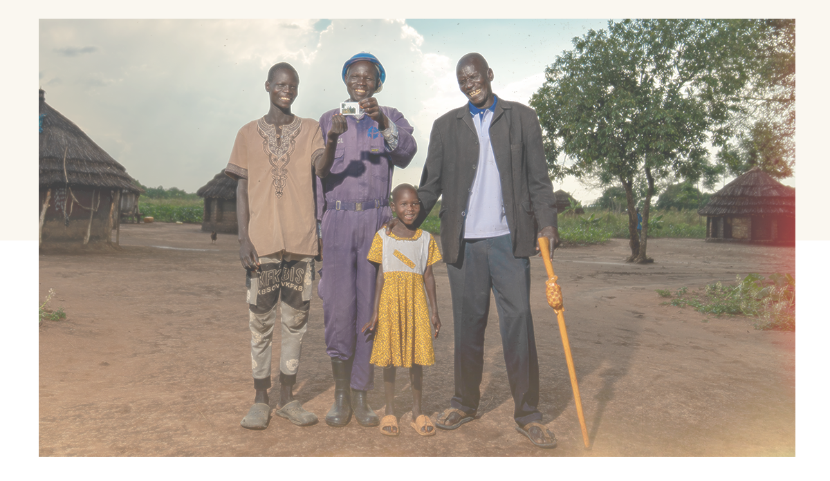 Mzee Bodo standing with his family smiling.